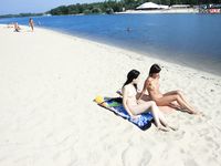 River Shallows Hold Three Nude Friends Under Summer Sun