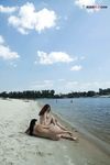 Quiet Shoreline Pause on Damp Nude Beach Sand
