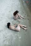 Quiet Shoreline Pause on Damp Nude Beach Sand
