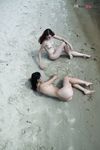 Quiet Shoreline Pause on Damp Nude Beach Sand