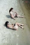 Quiet Shoreline Pause on Damp Nude Beach Sand