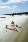 Quiet Shoreline Pause on Damp Nude Beach Sand