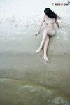 Quiet Shoreline Pause on Damp Nude Beach Sand