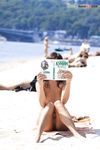 Lost in a Russian Paperback on a Sandy Nude Beach Towel