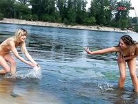 Side by Side Through Rippling Shallow Water Toward a Hazy Summer Shore