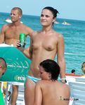 Playful naturist babes caught on a hidden camera enjoying a hot summer day at the beach
