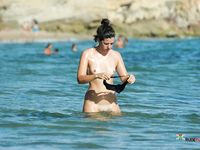 She lays on her towel and lets the sun warm her boobs up really quick