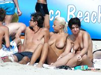 She goes out swimming, with her firm ass flashing, before her girlfriend with a smooth, shaved pussy joins the fun