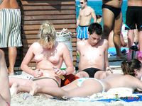 She goes out swimming, with her firm ass flashing, before her girlfriend with a smooth, shaved pussy joins the fun