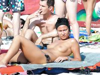 Two nudist ladies with juicy boobs swim in the sea at a naked beach