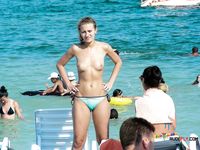 Two nudist ladies with juicy boobs swim in the sea at a naked beach