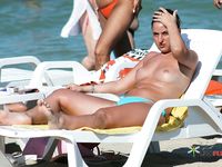 This cute brunette flaunts her perfect, firm tits while sitting topless and sunbathing outdoors