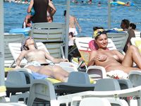 Voyeur catches a dashing mature hottie completely naked on the beach