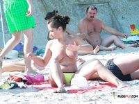 Blonde MILF amateur is enjoying her time on the beach while in nudist camp as she shows her natural tits and ass  for the voyeur