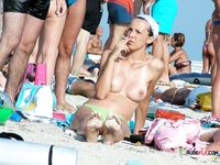 Blonde MILF amateur is enjoying her time on the beach while in nudist camp as she shows her natural tits and ass  for the voyeur