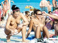 Gorgeous amateur brunette with sunglasses is enjoying her time in nudist camp as she challenges her man for a game of tennis while showing her small tits and pussy