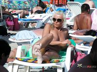 Chick talks on the phone and has fun at the naked beach without wearing a bra 2