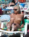 Chick talks on the phone and has fun at the naked beach without wearing a bra 2