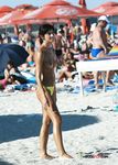 Multiple girls sit around in the sand and enjoy their day with perky tits and firm butts showing completely