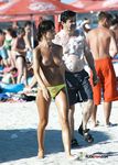 Multiple girls sit around in the sand and enjoy their day with perky tits and firm butts showing completely