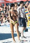 Multiple girls sit around in the sand and enjoy their day with perky tits and firm butts showing completely