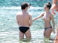 Beautiful brunette cuties with slim bodies and perky tits enjoy a sunny day at the beach sunbathing