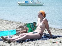 Beautiful brunette cuties with slim bodies and perky tits enjoy a sunny day at the beach sunbathing