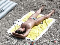 Beautiful brunette cuties with slim bodies and perky tits enjoy a sunny day at the beach sunbathing