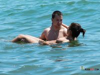 Nudist wife caught on camera setting up camp naked with her husband at the beach