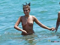 Nudist wife caught on camera setting up camp naked with her husband at the beach