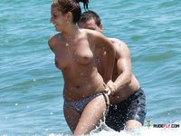 Nudist wife caught on camera setting up camp naked with her husband at the beach