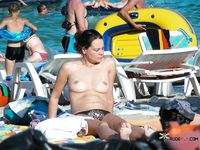 She spreads her legs and shows off her perfect, smooth pussy while sunbathing