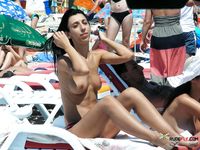 Two voluptuous sluts hang out on a naked beach while they talk about what they did last night and are they planning to do tonight