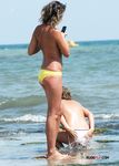 Adorable hottie with short, black hair and tiny tits sets up camp before lying down to sunbathe naked