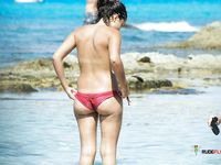 Woman with tiny tits literally just sits at a naked beach