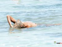 Woman with tiny tits literally just sits at a naked beach