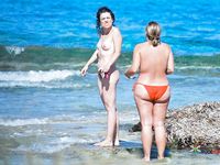 Three young Russian babes are alone in nudist camp as they are having snacks before enjoying getting in the sea, not knowing that they are being filmed