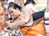 Multiple beautiful brunettes with slim bodies and perky tits fool around in the water and walk on the beach topless