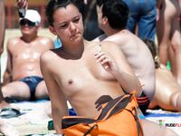 Multiple beautiful brunettes with slim bodies and perky tits fool around in the water and walk on the beach topless