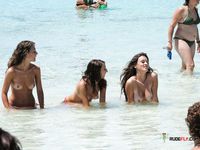 This cute brunette flaunts her perfect, firm tits while sitting topless and sunbathing outdoors 2