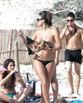 Beautiful nudist blonde fools around with her man at the beach