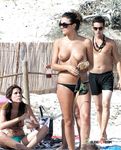 Beautiful nudist blonde fools around with her man at the beach
