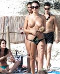 Beautiful nudist blonde fools around with her man at the beach