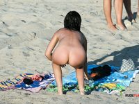 Sensual naturist blonde wife relaxes at the beach completely naked