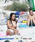 She sits around and relaxes with her massive, natural breasts and her smooth pussy on display 2