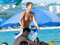 Two hot nudist girls are having a sunbathe at the beach while they read their favorite magazine and chat about men and sex