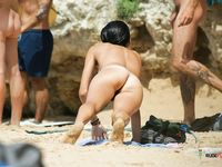 She wears nothing but colorful panties and shows off her magnificent, large breasts