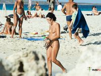 Phone in Hand on the Sand, Purple Cloth at Her Waist