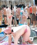 She covers her firm breasts and soft pussy in sunscreen before lying down with her ass showing
