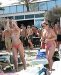She covers her firm breasts and soft pussy in sunscreen before lying down with her ass showing